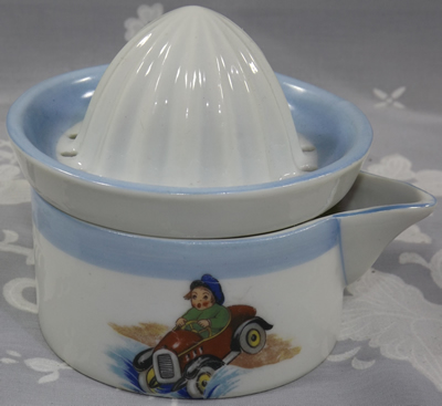Child in a car on a Limoges white and blue juicer with skier and car
