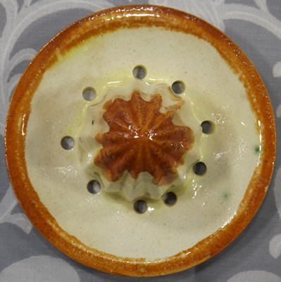 Multicoloured flowers on white Japanese strainer juicer front view
