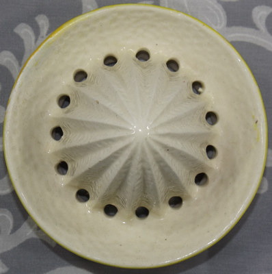 Yellow and white Manto Ware lemon skin juicer