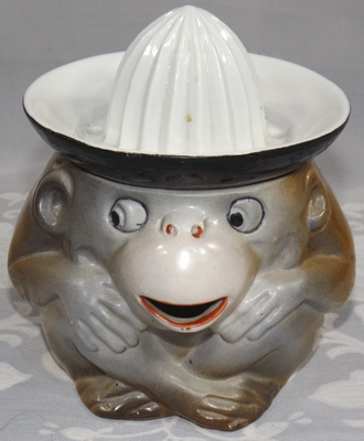 Brown monkey with black and white juicer front view