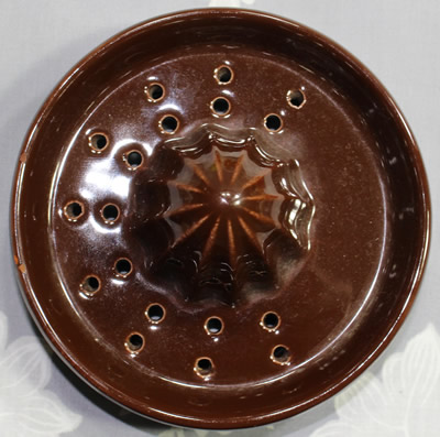 The reamer for a brown with orange flowers juicer jug