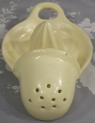 Front view of large cream hanging strainer juicer
