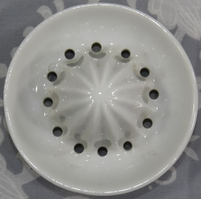 white reamer for Cottage garden flowers on a white ceramic juicer