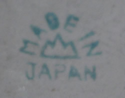 Mountain basemark on a green on white clown with orange and green hat juicer