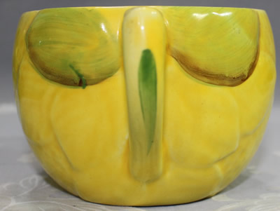 Leaves around the handle on a Royal Venton Ware yellow juicer