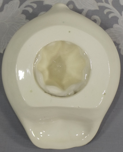 Base of Black on white saucer pig juicer