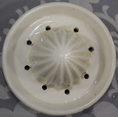 White 2 piece decorated with yellow flowers ceramic reamer