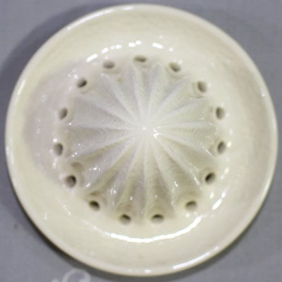 The reamer for a yellow and white 2 piece Crown Devon peel texture juicer
