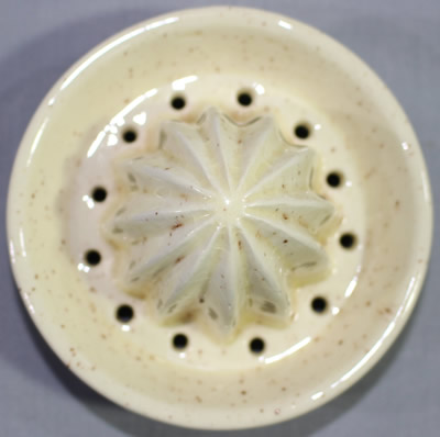 reamer on Flowers and fruit on speckled cream ceramic juicer