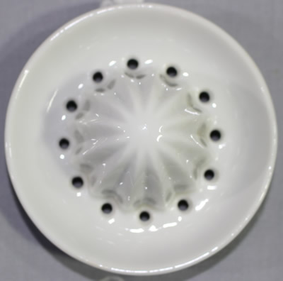 Reamer for Lattice and lemons on white ceramic jug juicer