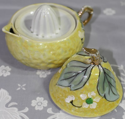 3 parts of a Pale yellow with white flowers pear shape juicer