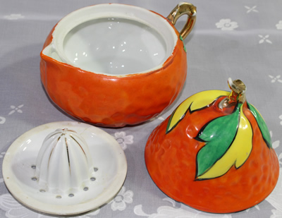 3 parts of a Orange with green and yellow leaves pear shape juicer