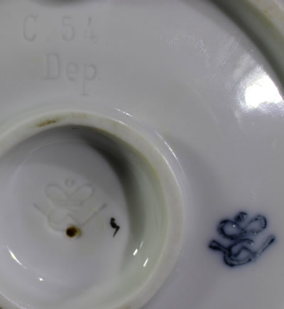The base of a Goebel frowning face clown saucer juicer