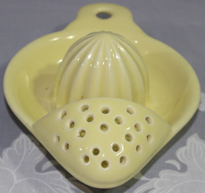 Front view of pale yellow English strainer juicer 