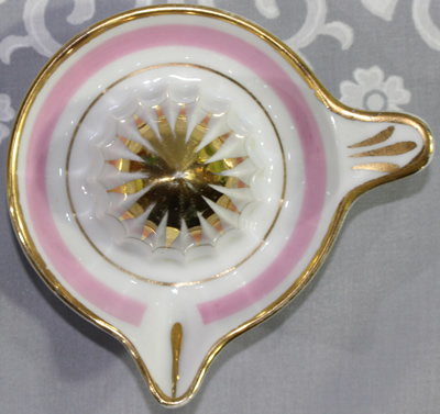 Top view of a small white with gold and pink highlights juicer