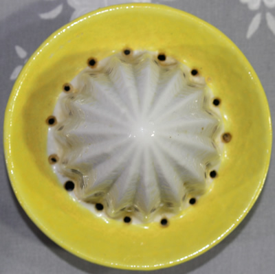 Reamer for a yellow 'peel' with white and green ceramic juicer