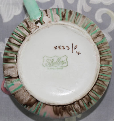 The base of a pink and green Shelley dripware juicer