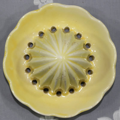 The reamer for a yellow Carlton Ware flower basket pattern juicer