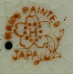 The basemark on an orange and cream spiral cone jug like juicer