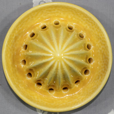 The reamer for a yellow 2 piece Crown Devon peel texture juicer