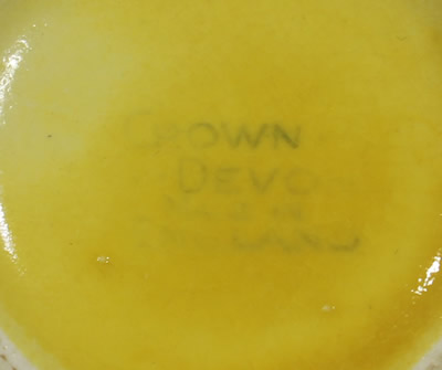The basemark on a yellow 2 piece Crown Devon peel texture juicer 