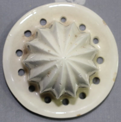 The reamer for a ceramic orange jug with a small white top ceramic juicer