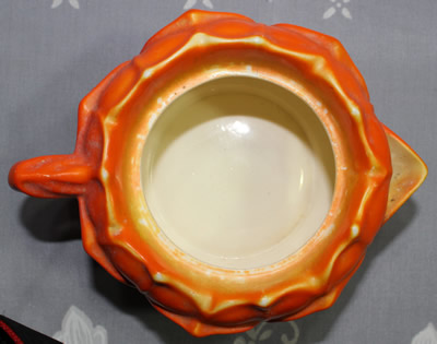 Top view of a ceramic flower shaped orange ceramic juicer
