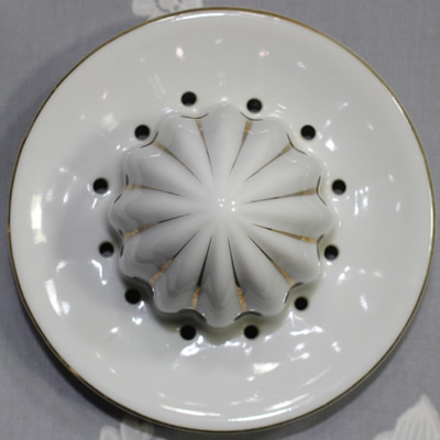 The reamer for a white polka dots on a blue juicer with white reamer