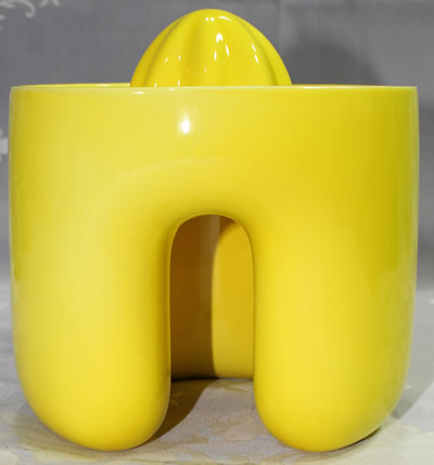 The back view of a yellow Royal Copenhagen 1 piece juicer