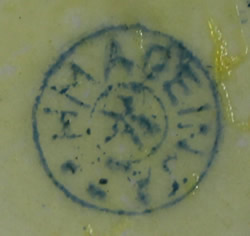 The basemark on a 5¼" blue, yellow and white clown juicer