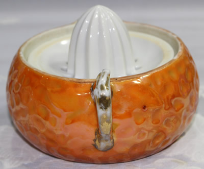 Showing the orange leaves on an orange pear shape juicer