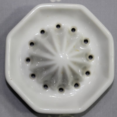 The reamer for a duck on an octagonal white ceramic juicer