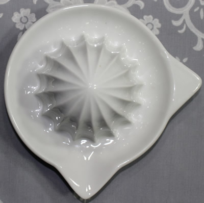 The top view of a Deshoulières white ceramic saucer shape juicer