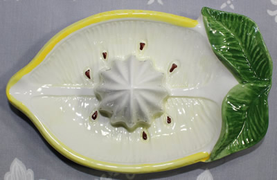 Top view of a large sliced lemon ceramic juicer