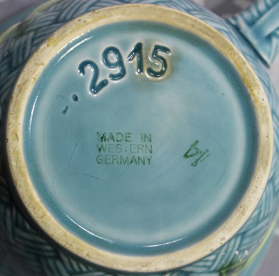 The base of a lemons on a blue ceramic jug juicer