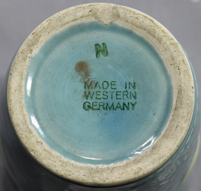 The base of a tumbler for a lemons on a blue ceramic jug juicer
