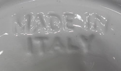 The impressed mark on a yellow reamer in a green leaf ceramic jug like juicer