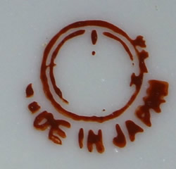 The partial Maruyama Toki basemark on a yellow and white 'peel' 2 piece juicer