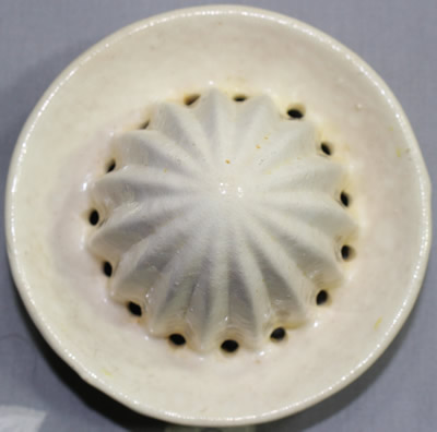 The reamer for a yellow and white 'peel' texture ceramic juicer