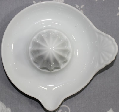 Top view of a white SAKANA tab handle ceramic juicer