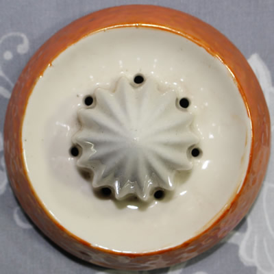 The reamer for an 'ORANGE' on peel texture orange juicer with green leaves