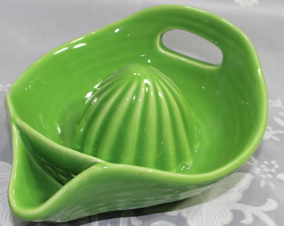 Front view of a large green Fiesta ware juicer