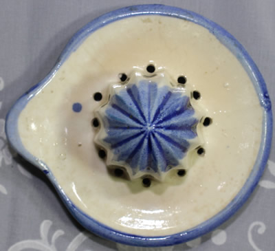 The reamer for a blue & white with black windmill juicer with 4 tumblers