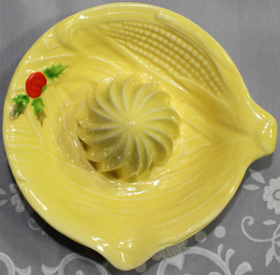 Top view of a yellow corn and a holly berry on a Maruhon Ware juicer