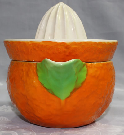 The green leaves at the pouring spout on an orange 'peel' and white top Fielding juicer 