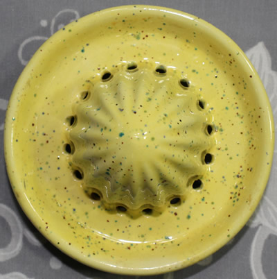 The reamer for a speckled yellow 2 piece ceramic jug juicer with rivets