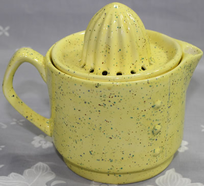 The rivets on a speckled yellow 2 piece ceramic jug juicer