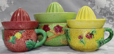 Size comparison of a green with maroon flowers 2 piece ceramic juicer