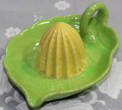 An alternate view of a green leaf with yellow reamer ceramic juicer 