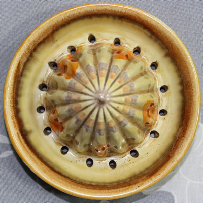 The reamer for a Shelley orange, grey and brown drip glaze juicer